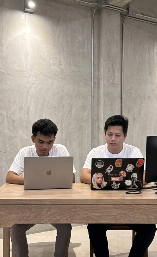 Two people smiling, one holding a cup